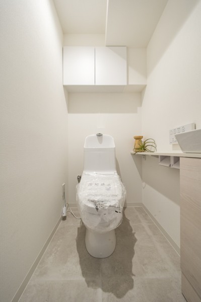 手洗い場付きのレストルームです。カウンターや吊戸棚など有効的に使えそうな設備を設置。毎日使う場所だからこそ、清潔感と使いやすさを考慮した空間です。