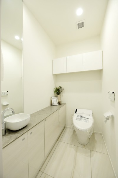 タンクレストイレを採用、手洗いカウンターを設置しており家族もゲストも清潔・快適にご使用頂けます。使いやすい高さの吊戸棚が設置され、小物類もしっかりと収納出来ます