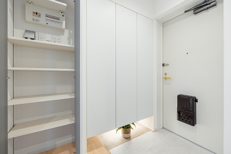 フットライトからのびる光が足元を優しく包み込む気品溢れる玄関です。頼もしい収納力をもつシューズボックスを備え付けました