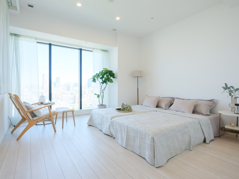 約11.4帖の広さを誇る洋室1は、都会のビル群を一望するプライベートルームです。開口部の大きな窓からめいっぱいの自然光が降り注ぎ、伸びやかな時間が流れます。