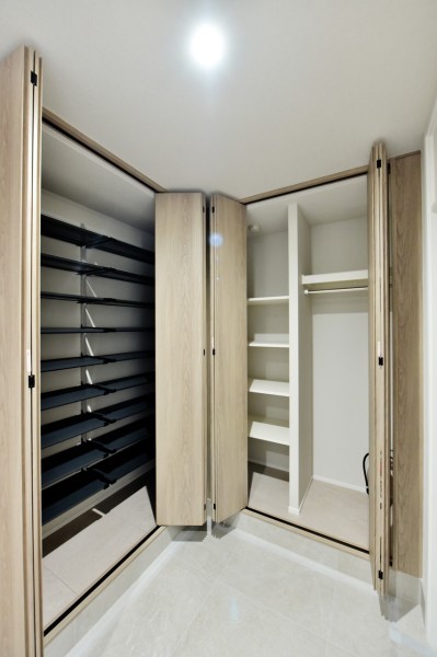 玄関にはシューズボックス以外にも大容量の収納スペースを設けました。お出かけの際にサッと取り出したいレイングッズや羽織物をかけられるハンガーパイプを設置した使い勝手の良い収納です。